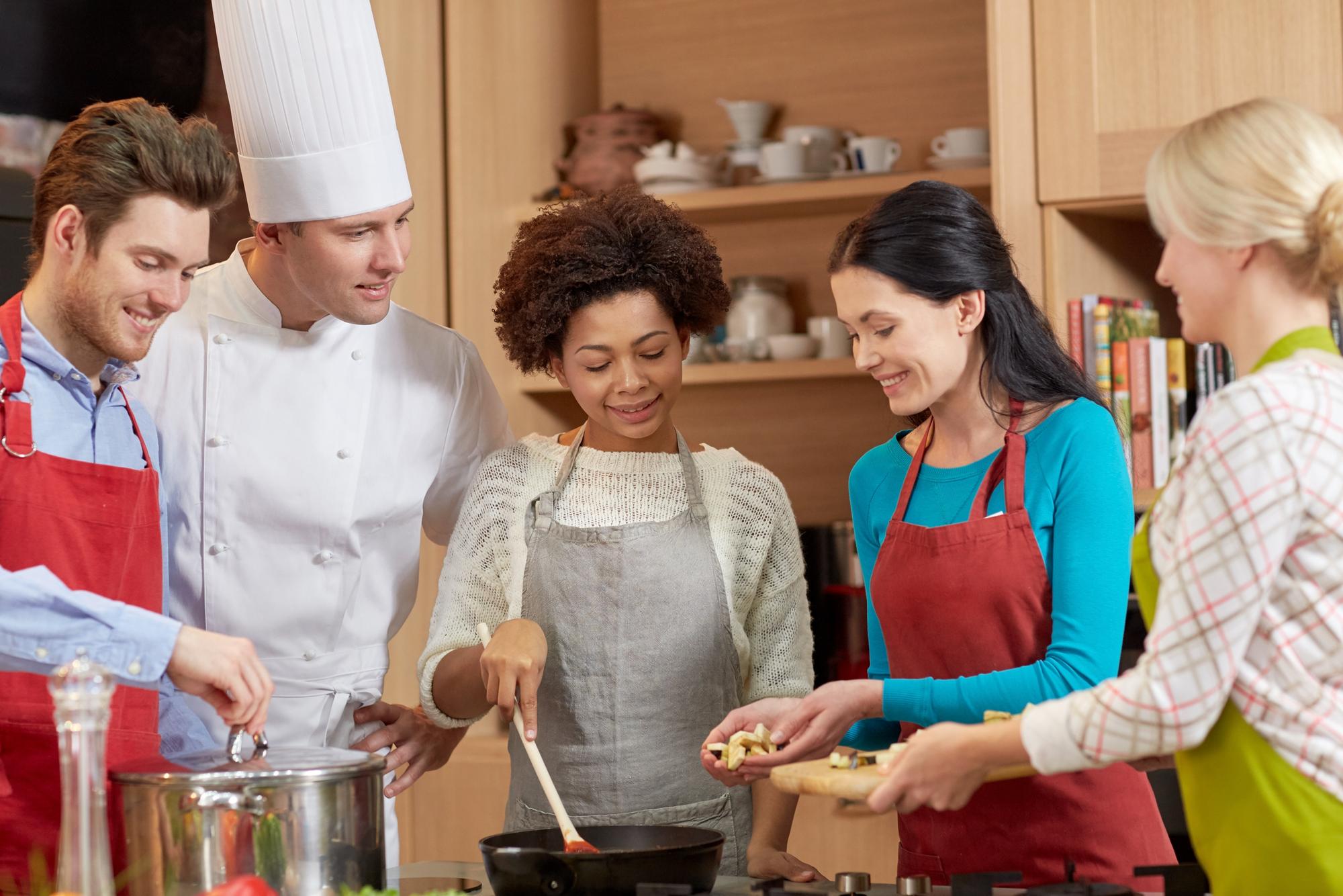 Workshop kitchen with chef demonstrating technique